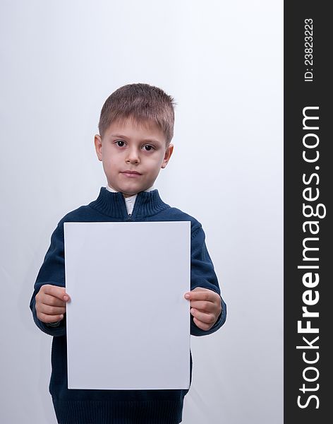 Child with the white sheet of paper.