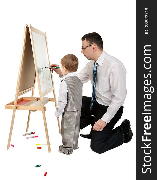 Businessman teaches his son to paint on an easel