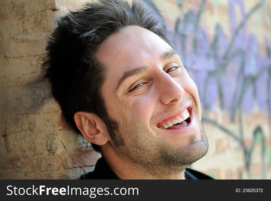 Portrait of happy man in urban background