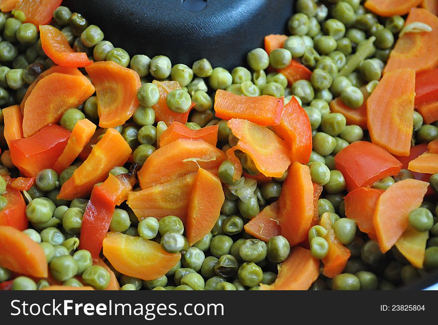 Orange carrot, red pepper and green peas boiled and mixed. Orange carrot, red pepper and green peas boiled and mixed.