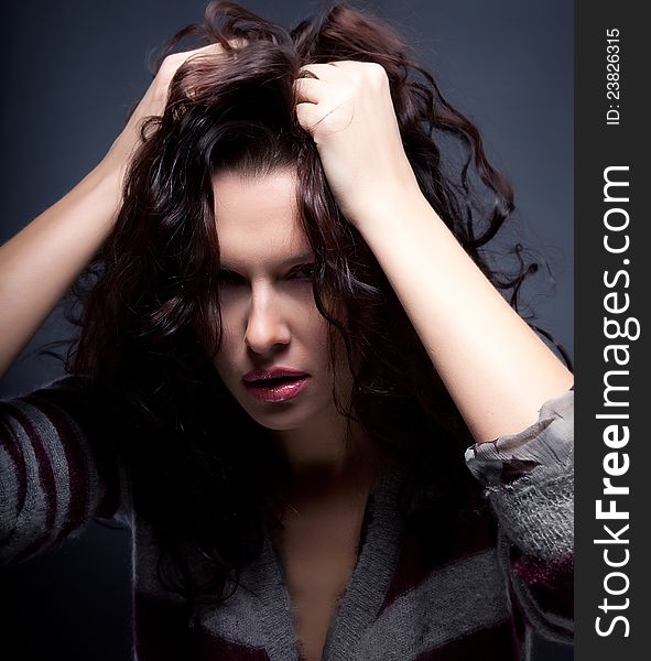 Astounded brunette female stressed is going crazy pulling her brown hair in frustration. Astounded brunette female stressed is going crazy pulling her brown hair in frustration