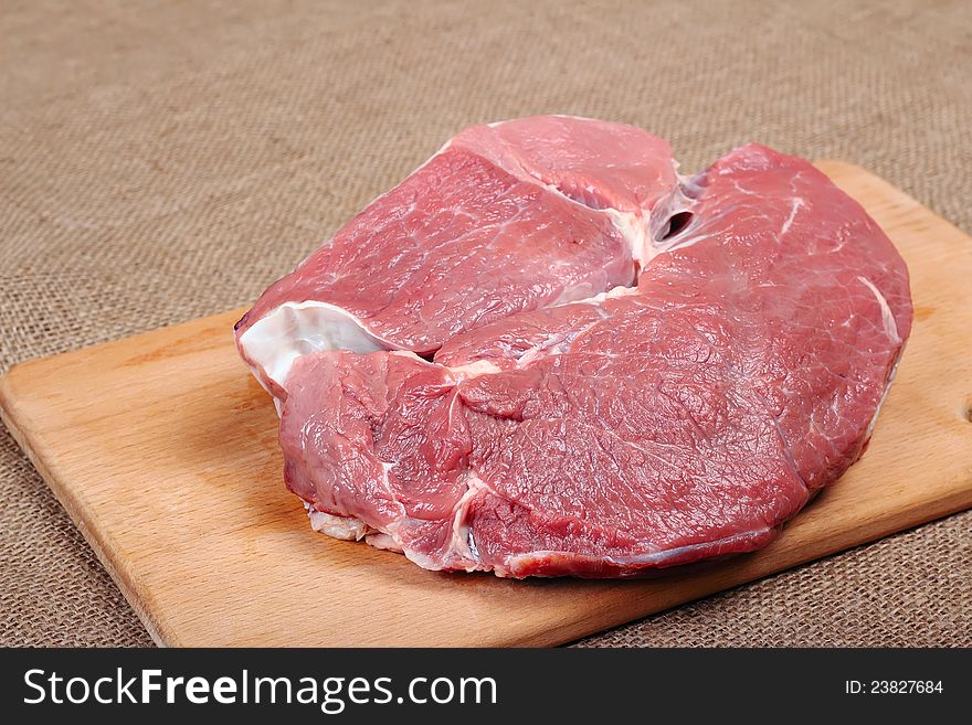 Piece of fresh beef on a wooden board