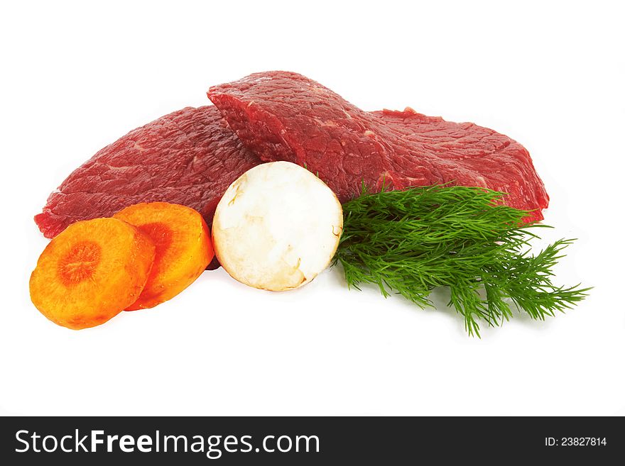 Raw meat and vegetables on white