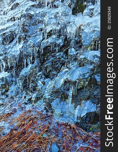 Frozen water on side of mountain in Shenandoah Valley, Virginia. Water was falling on leafs.