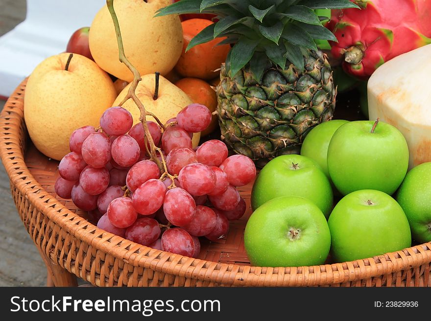 Various fruits on rattan basket.