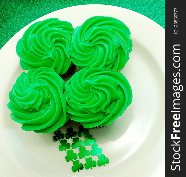 Four cupcakes placed together to shape a shamrock. A festive display for Saint Patricks Day. Four cupcakes placed together to shape a shamrock. A festive display for Saint Patricks Day.