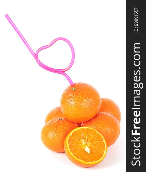 Concept of loving fresh mandarin juice with a straw bent in the shape of a heart inserted into a pile of fresh mandarins. Concept of loving fresh mandarin juice with a straw bent in the shape of a heart inserted into a pile of fresh mandarins