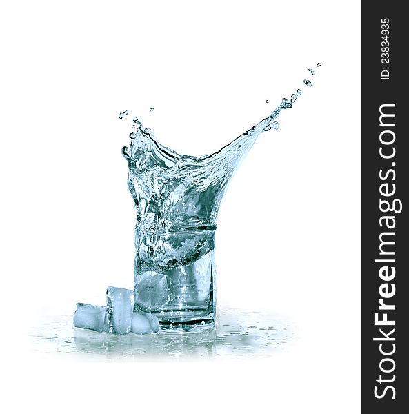 Glass of splashing water near ice cubes on white background. Clipping path is included. Glass of splashing water near ice cubes on white background. Clipping path is included