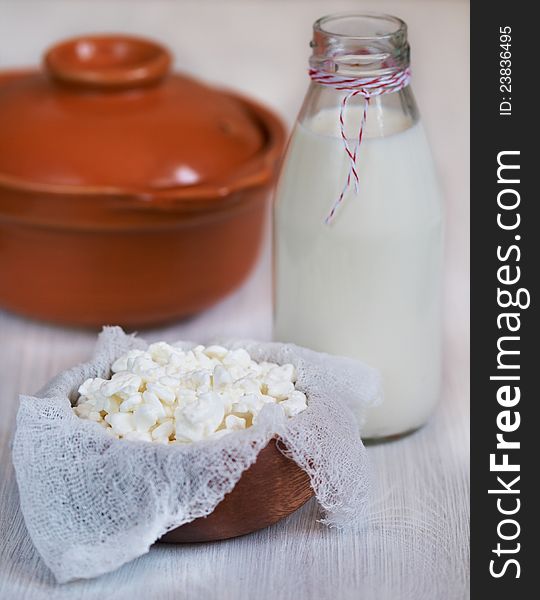 Fresh milk and cottage cheese in wooden bowl. Fresh milk and cottage cheese in wooden bowl