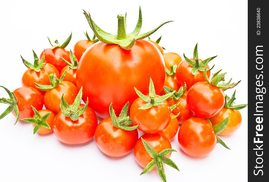 A many small tomatos and one big. A many small tomatos and one big