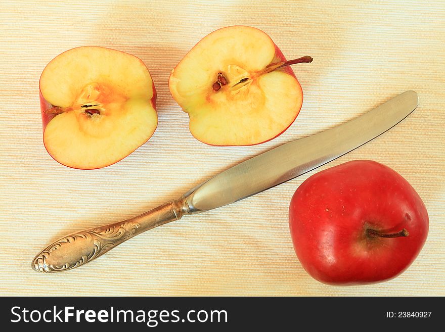 Red apples and knife cut apple