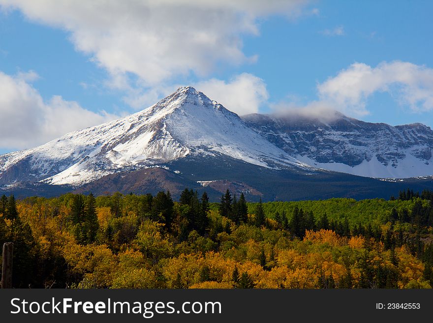 This image of the mountain peak covered in fresh snow with the beautiful autumn colors was taken in Glacier National Park, MT. This image of the mountain peak covered in fresh snow with the beautiful autumn colors was taken in Glacier National Park, MT.