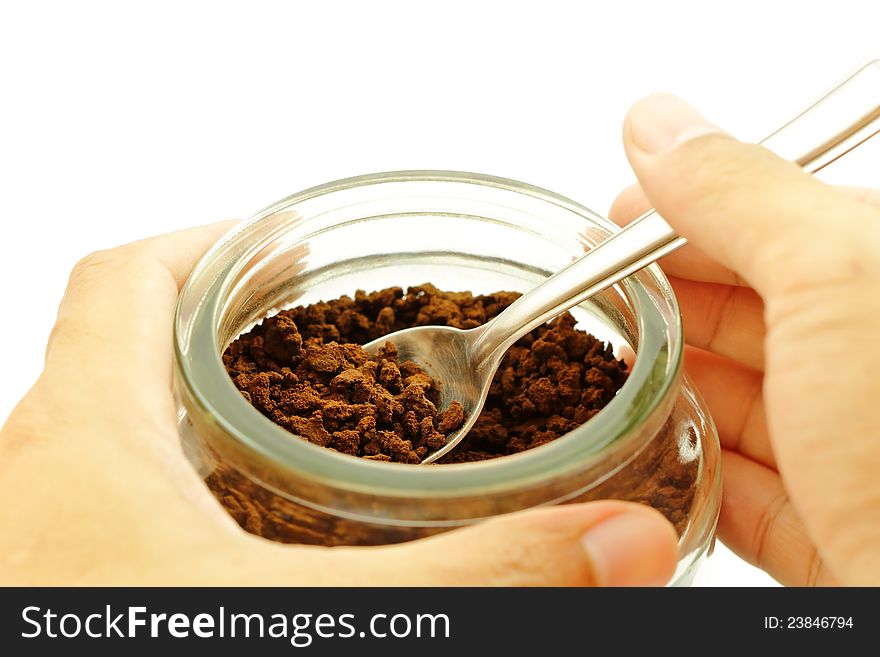 Coffee scoop with a spoon in a glass jar. Coffee scoop with a spoon in a glass jar