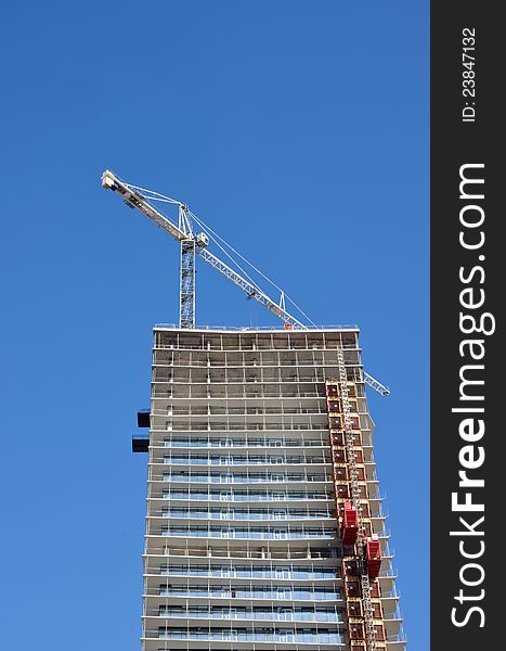 Construction of condominium tower with crane. Construction of condominium tower with crane