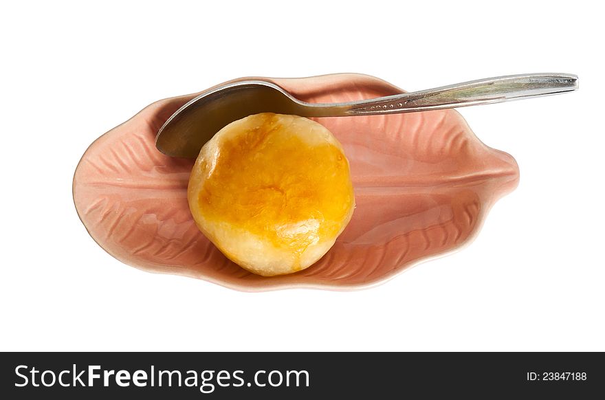 Moon cake in dish with teaspoon