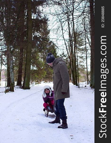 Father with daughter in winter fun, vertical image