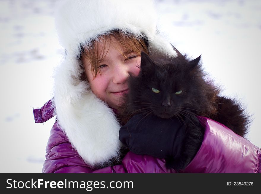 Kid Girl Holding Black Cat And Smiling