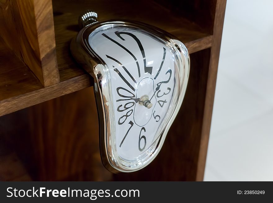 Photo creative decorative clock on a wooden shelf. Photo creative decorative clock on a wooden shelf