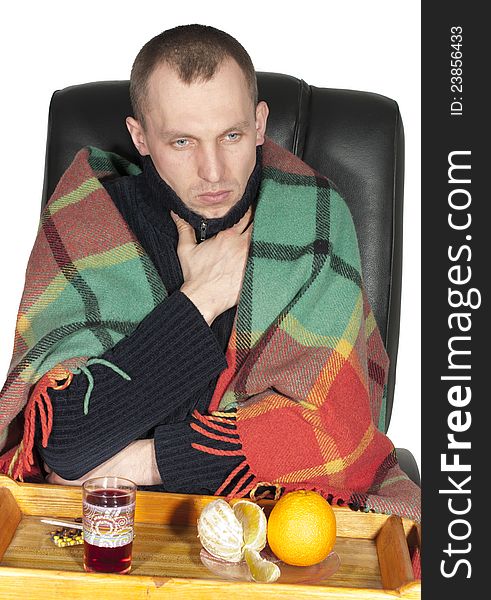 Sick man wrapped in a blanket on white