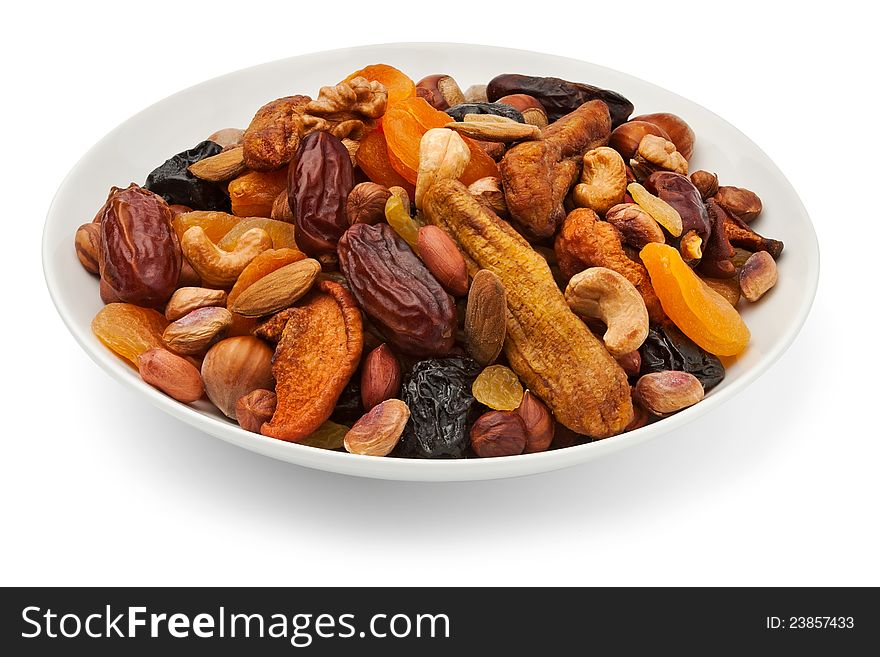 Mixed dry fruits on a plate against white background