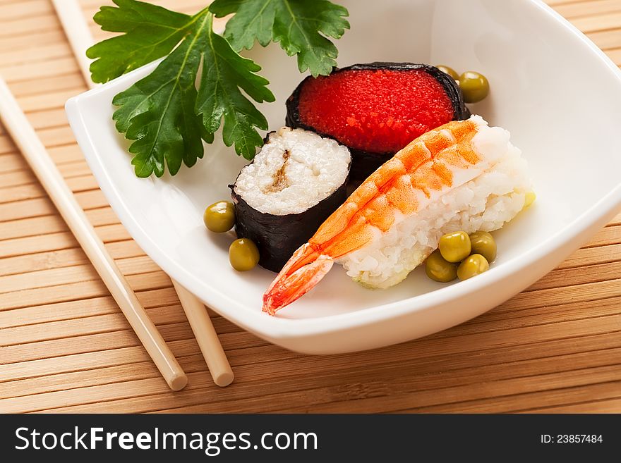 Sushi in a bowl on a wooden napkin
