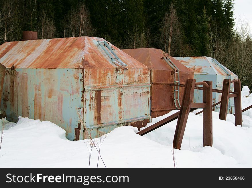 Rusty old containers dumped in a forest