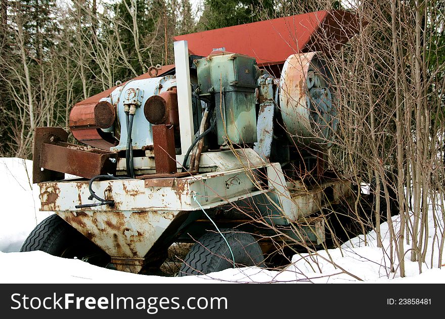 Rusty old machine dumped in a forest