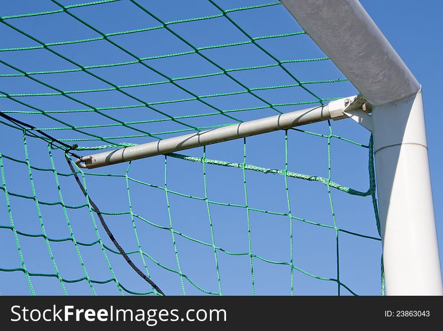 Close-up of a goal against blue sky