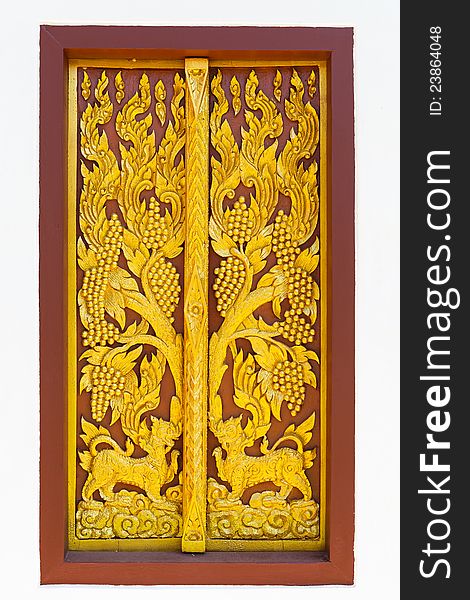 Art of traditional Thai style Carved wooden on door of the temple