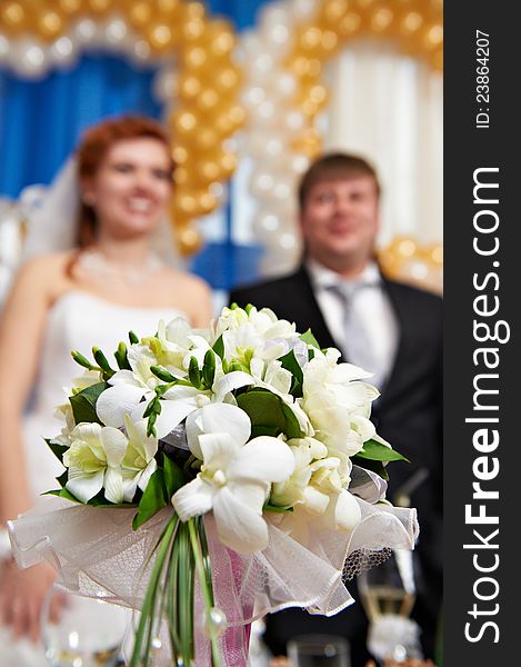 Wedding Bouquet And Newlyweds