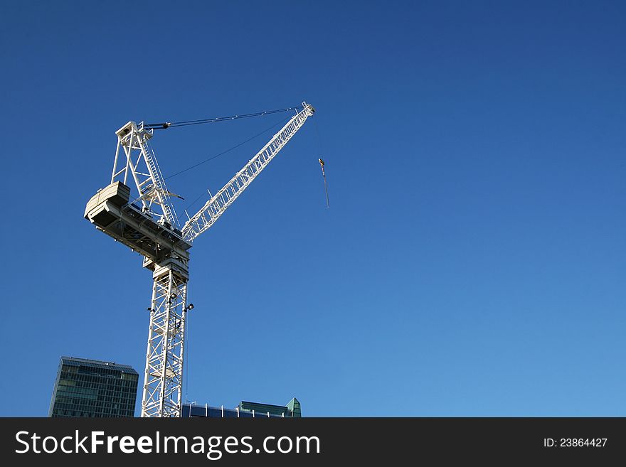 A construction tower cran against blue sky,Toronto,Canada. A construction tower cran against blue sky,Toronto,Canada