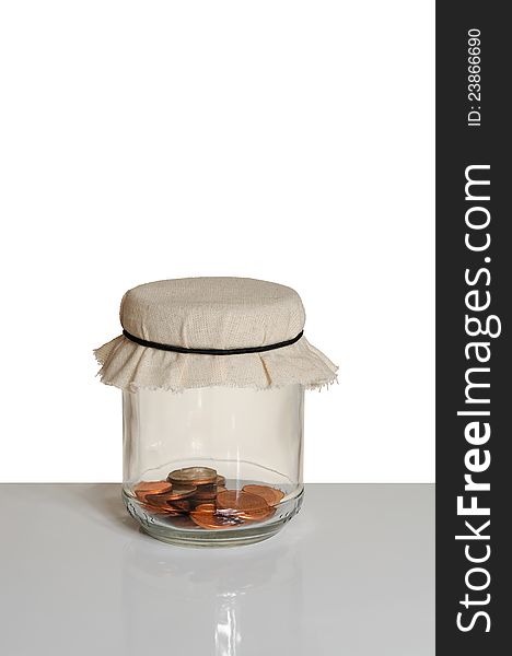 Coins in a jar on white background. Coins in a jar on white background