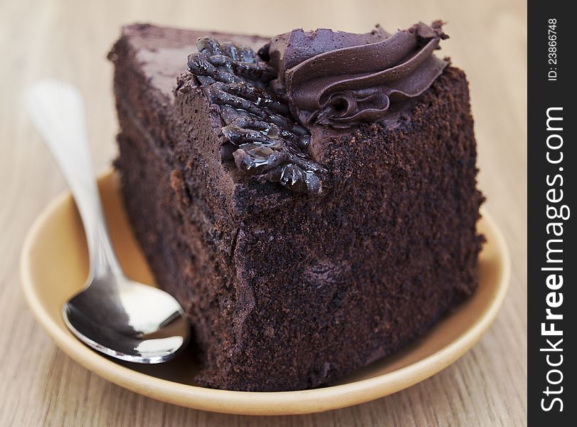 Plate with slice of chocolate cake on the table