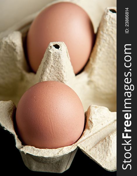 Eggs in a package in black background close up