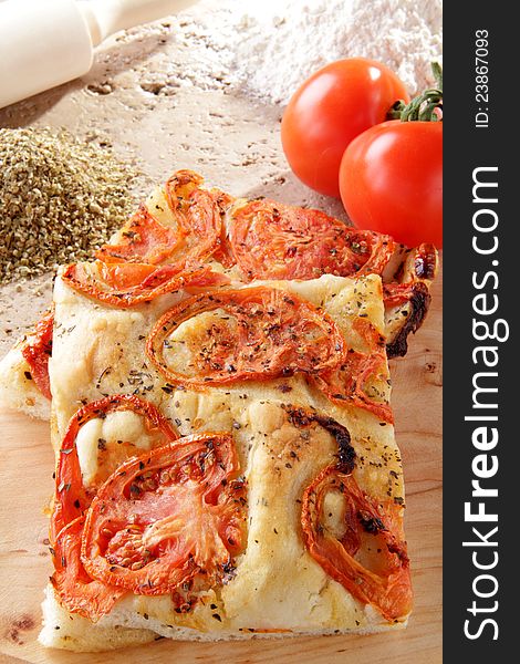 Delicious pizza handmade whit chopped tomato on the table. Delicious pizza handmade whit chopped tomato on the table