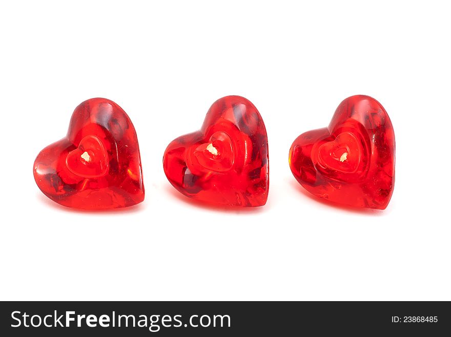 Triple red hearth candles isolated on white background.