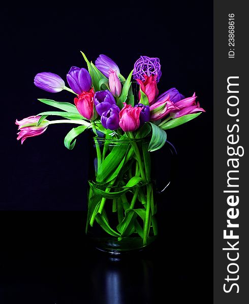 Colorful tulips in green vase. Colorful tulips in green vase