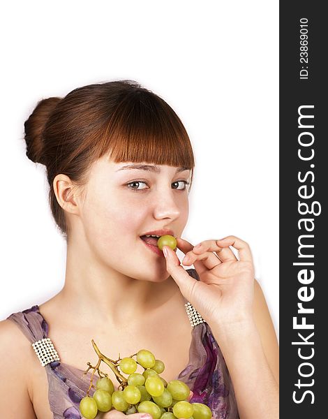 Sensual pretty girl eating grapes over white background. Sensual pretty girl eating grapes over white background