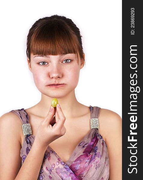 Funny cute girl eating grapes over white background. Funny cute girl eating grapes over white background