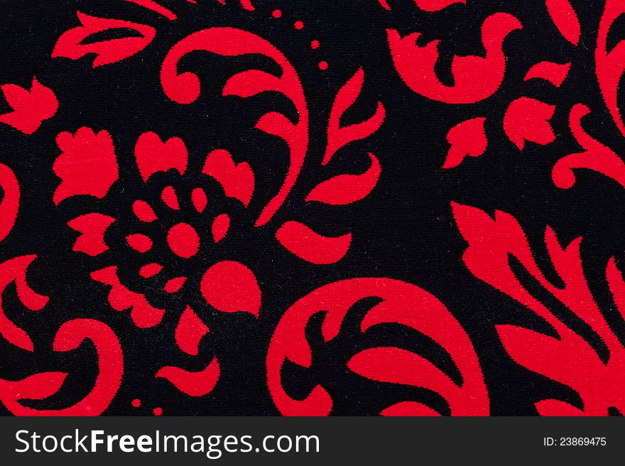 Close-up photo of red-black, mild, patterned carpet. Close-up photo of red-black, mild, patterned carpet