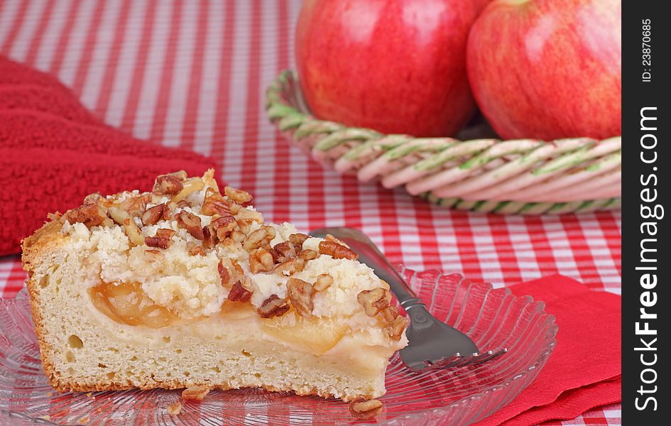 Slice of apple nut coffee cake on a plate