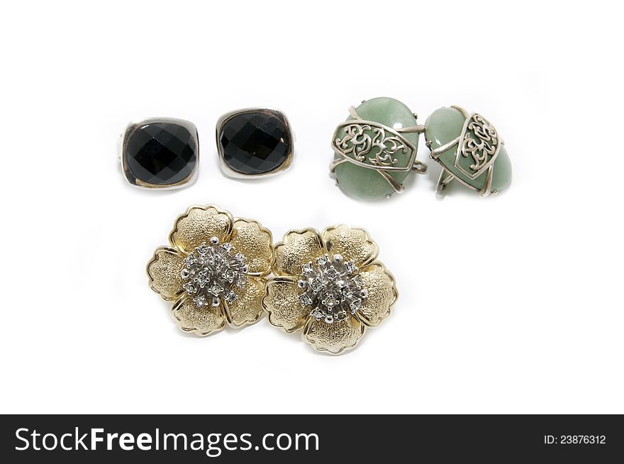 Several pairs of earrings on a white background