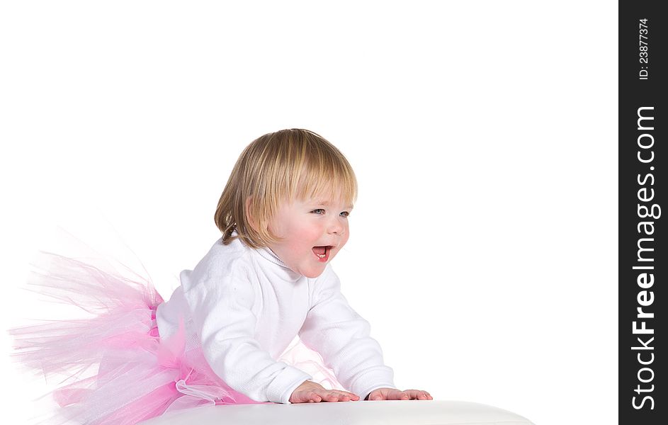 Happy laughing little girl in tutu is based on the cube