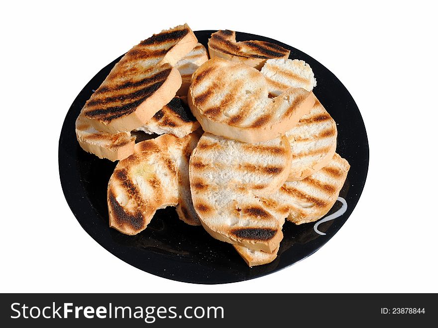 Grilled slices of bread on a dish isolated on white background