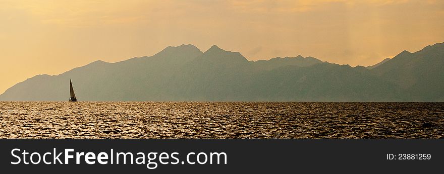 Lonely yacht on the background of the mountains