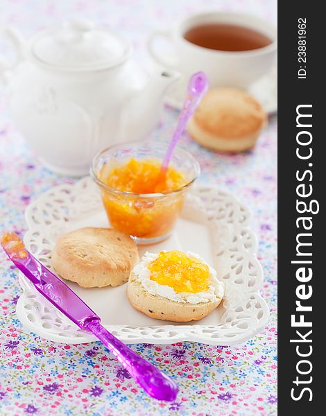 Orange scones with lavender, served with fresh cheese and orange jam, selective focus