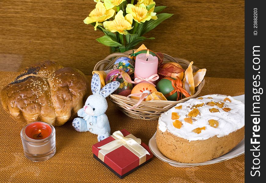 Holiday Arrangement to Easter. Easter bread, gift, rabbit and colored eggs