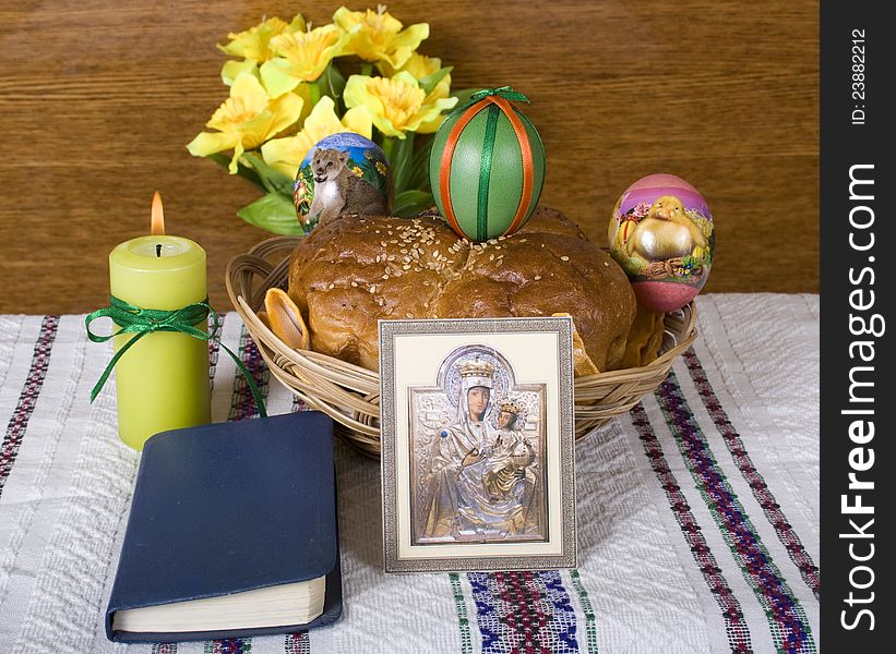 Lighted candle, Easter bread and colored eggs icon and the Bible. Lighted candle, Easter bread and colored eggs icon and the Bible