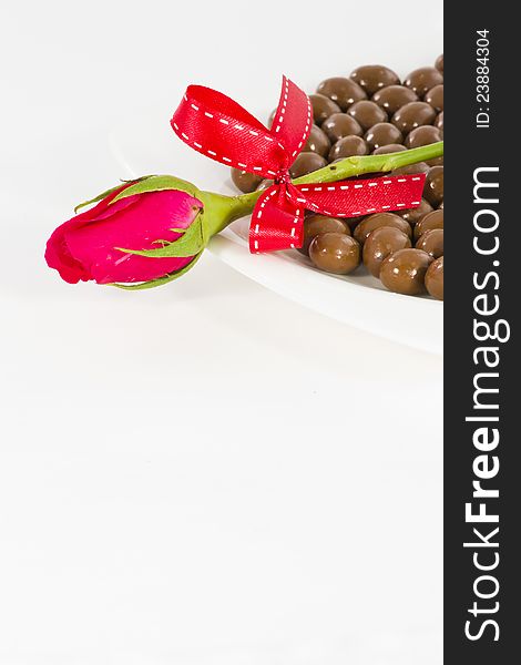 Chocolate and rose in the Valentine's Day on white background. Chocolate and rose in the Valentine's Day on white background