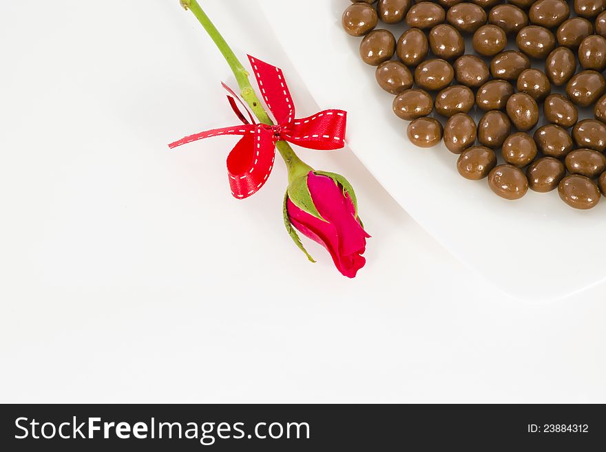 Chocolate and rose in the Valentine's Day on white background. Chocolate and rose in the Valentine's Day on white background